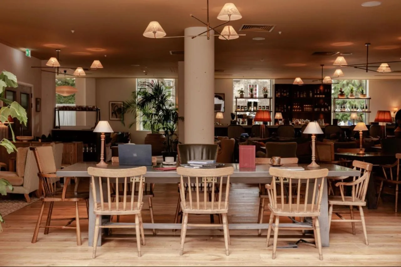 a restaurant with chairs and a table and a bar at Wilde Cambridge City Centre in Cambridge
